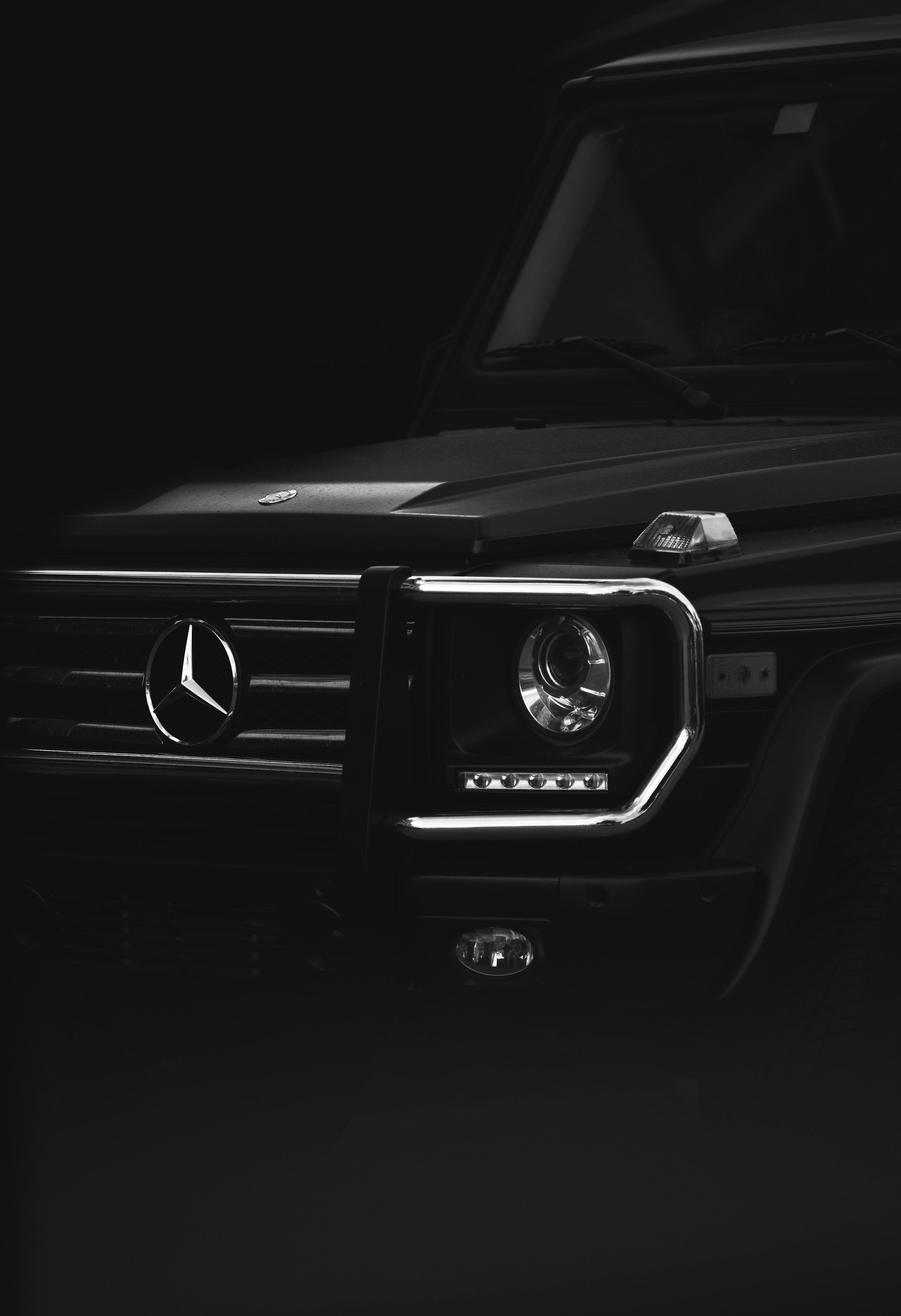 A black Mercedes G-Class parked in garage